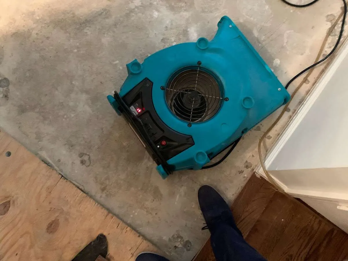 Air mover drying subfloor during Commercial Water Damage Restoration in Santa Fe Springs